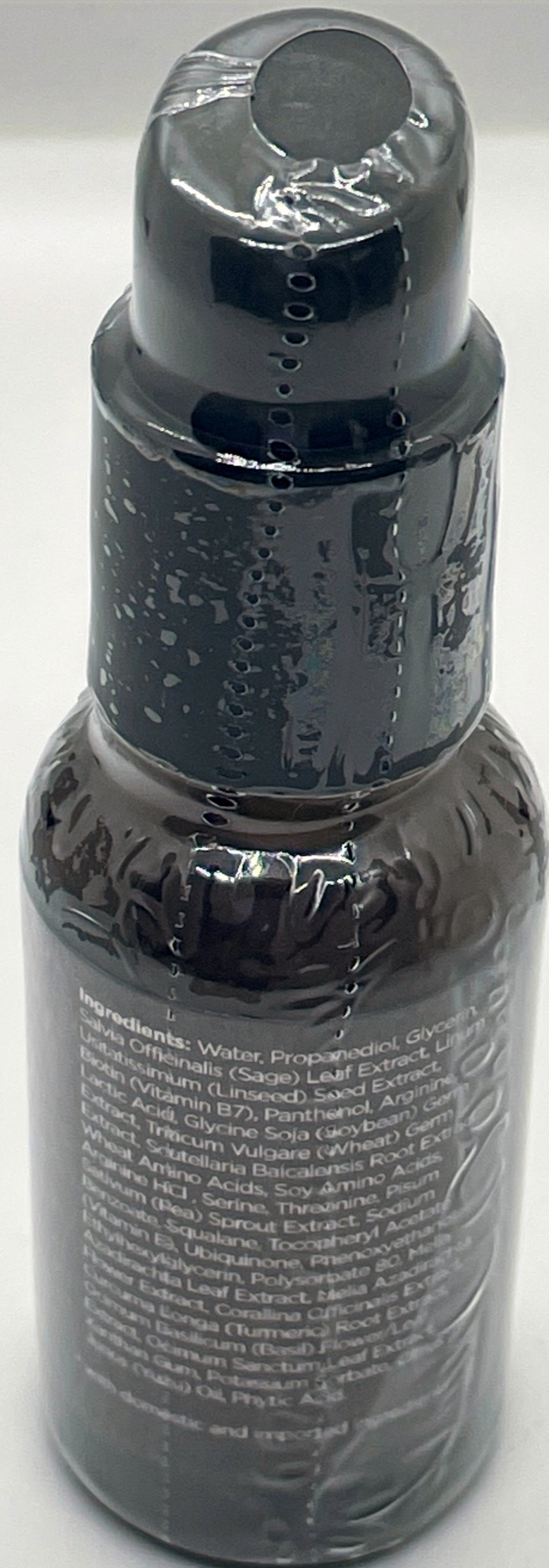 Biotin Boost Hair Serum in a sleek black bottle with a pump cap for easy application.