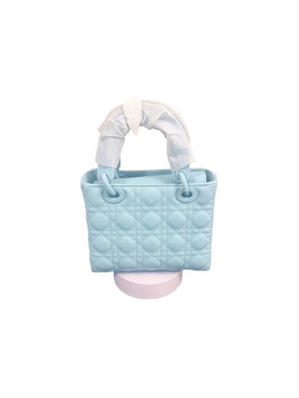 Lumivelle handbag in Ion Blue featuring GeoQuilt texture and structured frame on display.